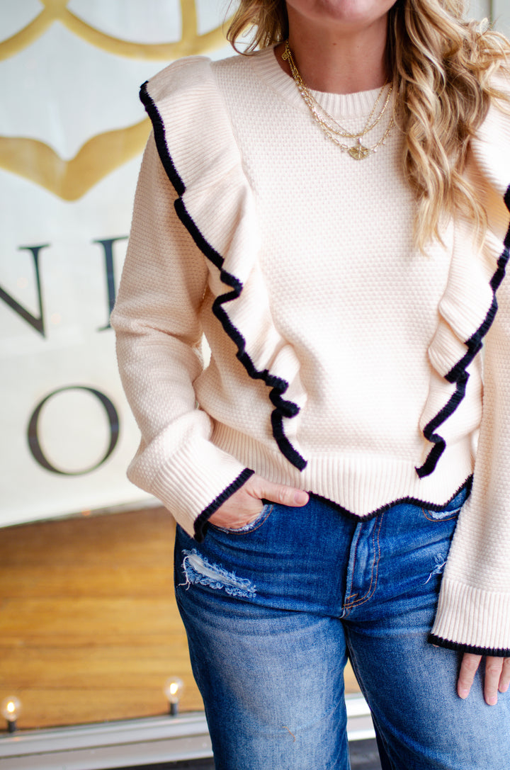 Walk The Line Long Sleeve Cream Knit Sweater with a Black Trim Ruffle Detail