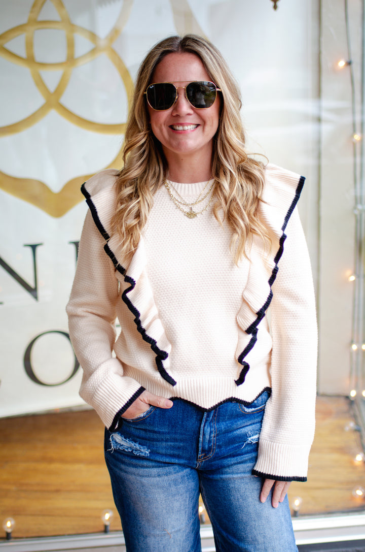 Walk The Line Long Sleeve Cream Knit Sweater with a Black Trim Ruffle Detail